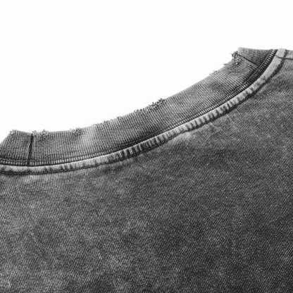 Macro view of folded 240 GSM heavyweight cotton fabric showing vintage acid wash texture.