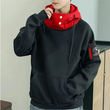 Person wearing a black and red hoodie with a visible brand logo.
