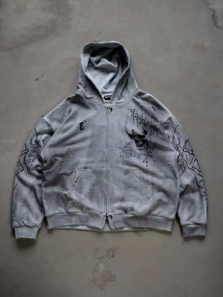 Front view of a heather grey heavyweight cotton zip-up hoodie featuring a gothic skull graphic and Berserk sleeve prints by Skaiiy.