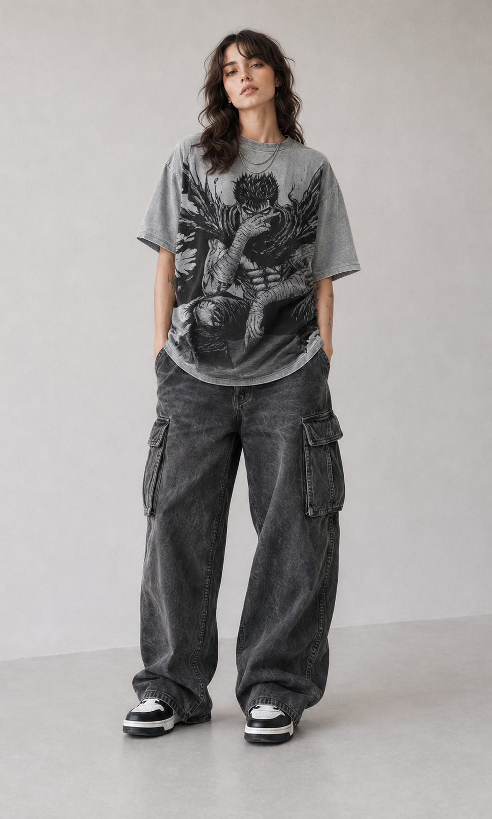 Female model wearing Berserk Guts Seated Manga Oversized T-Shirt