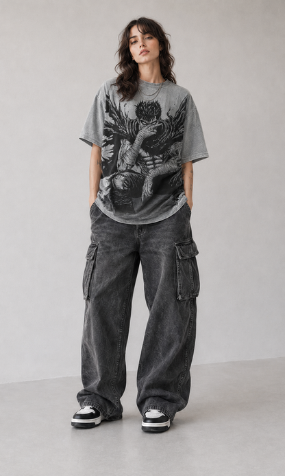 Female model wearing Berserk Guts Seated Manga Oversized T-Shirt