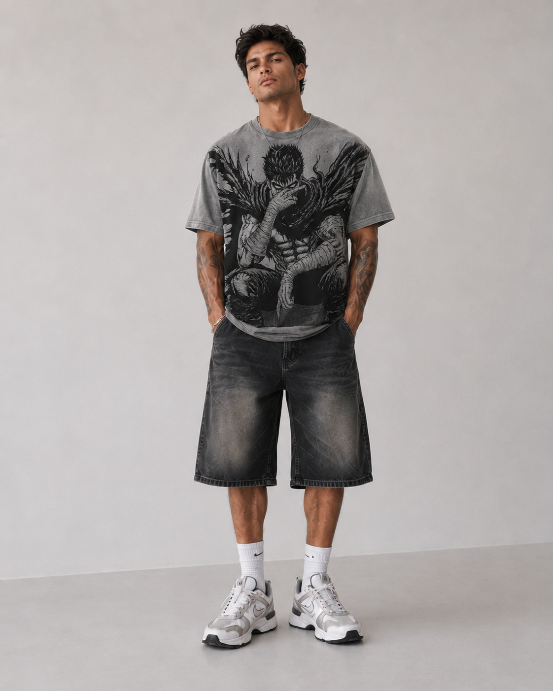 Male model wearing Berserk Guts Seated Manga Oversized T-Shirt
