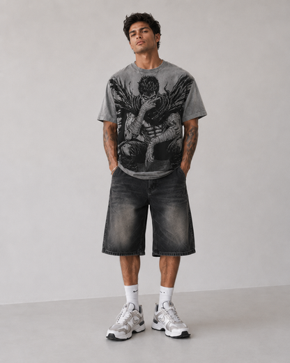 Male model wearing Berserk Guts Seated Manga Oversized T-Shirt