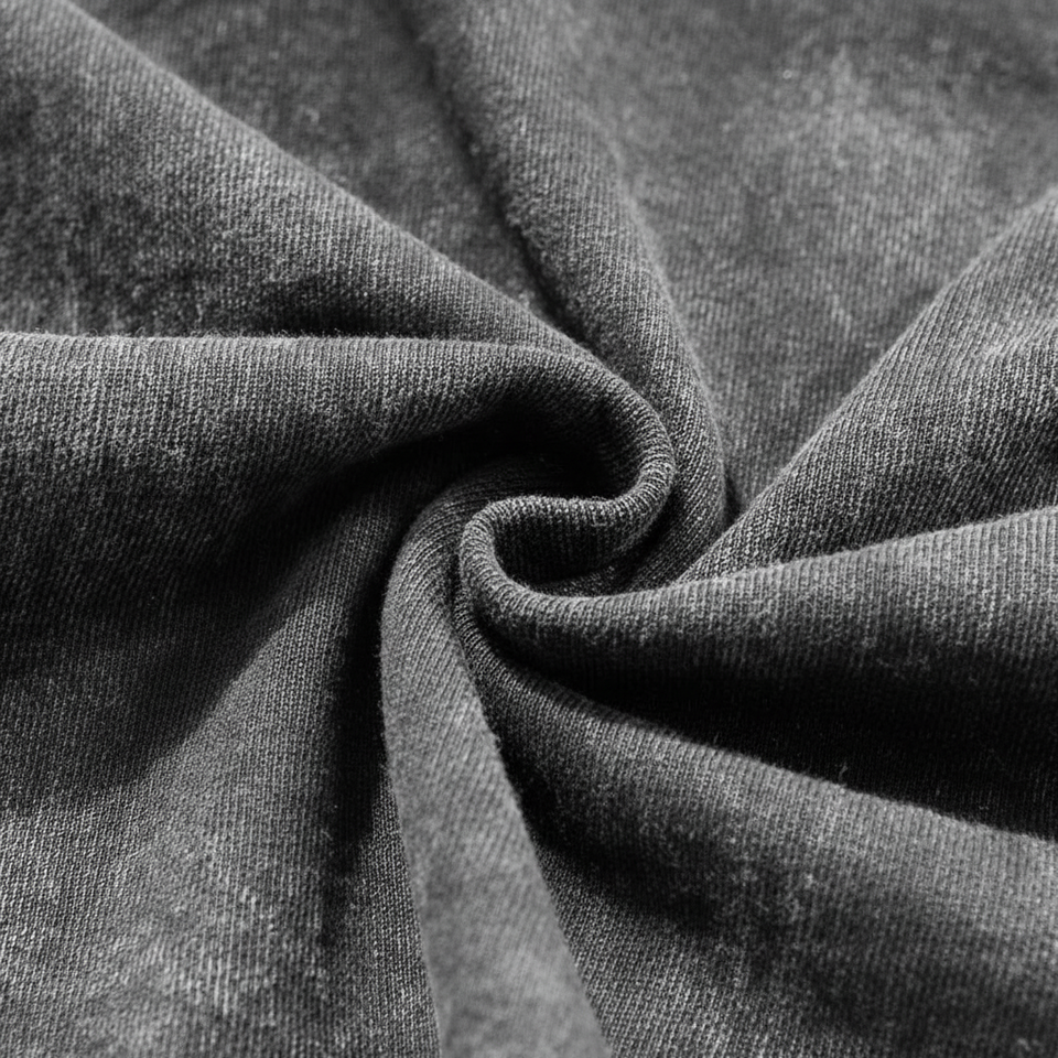 Close up of distressed frayed ribbed collar on a vintage grey acid wash heavyweight t-shirt.