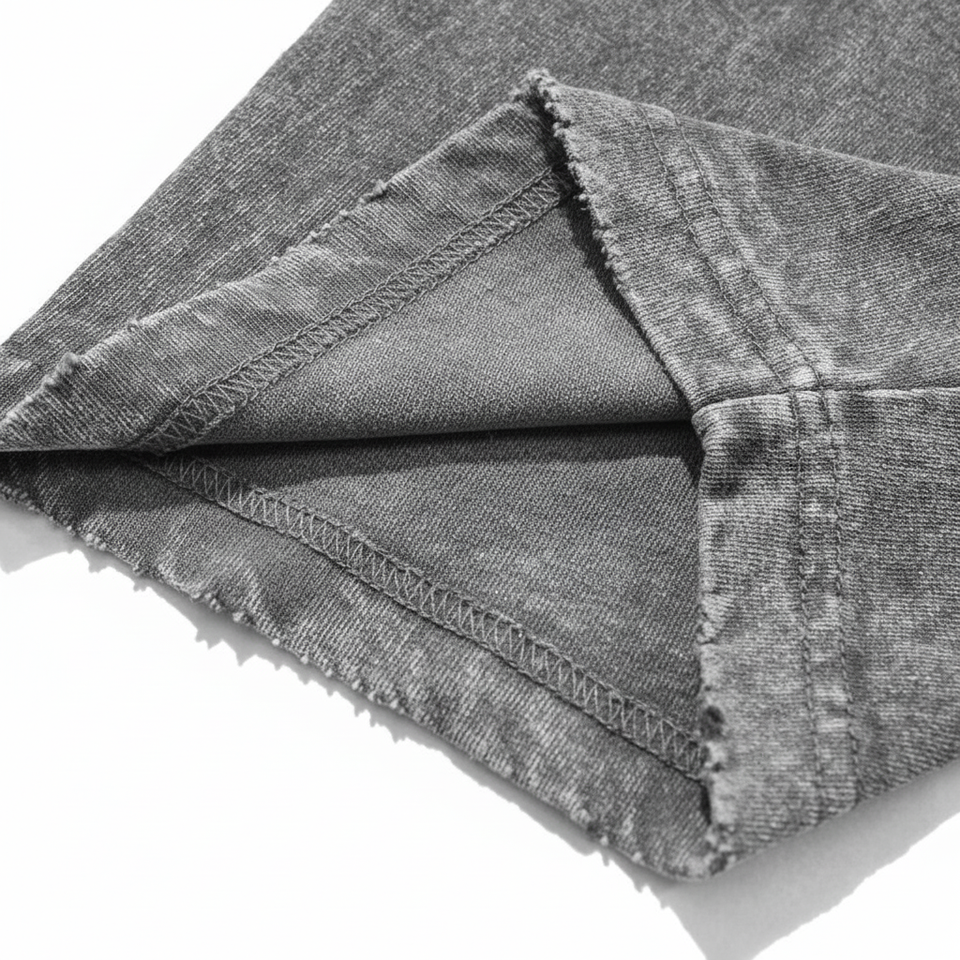 Close up of distressed bottom hem and double needle stitching on 240 GSM acid wash cotton.