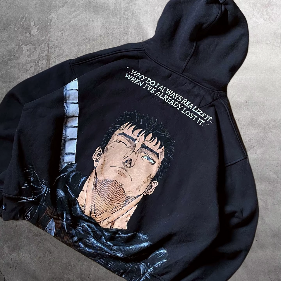 Angled view of the oversized black Berserk hoodie highlighting the back Guts manga graphic and drop-shoulder fit